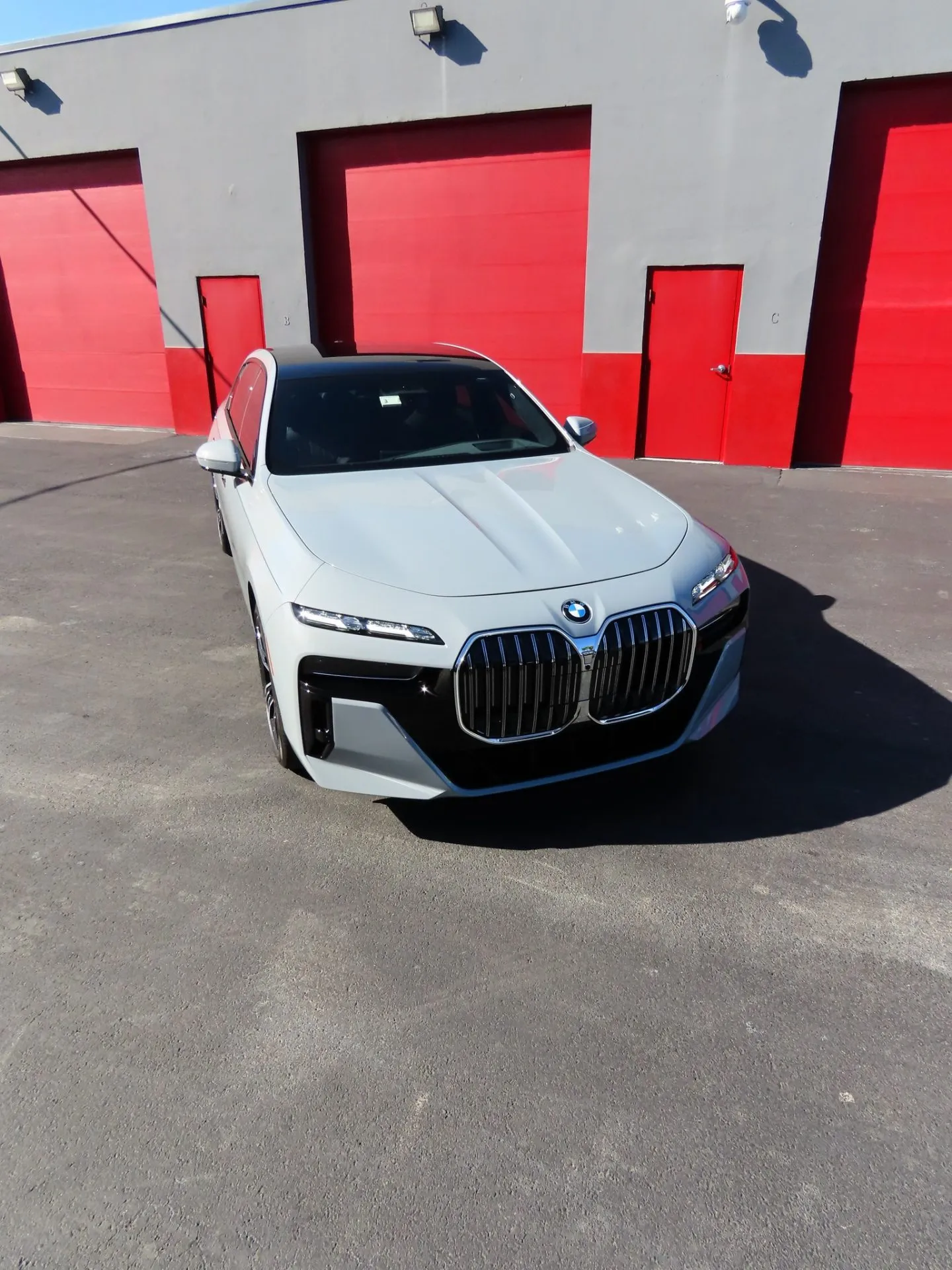 White BMW 7 Series outside the Advanced Detailing Sofla studio